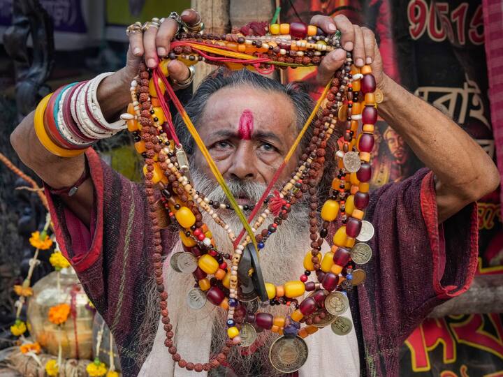 A sadhu prays at a transit camp in Kolkata before resuming his journey to Sagar Island.