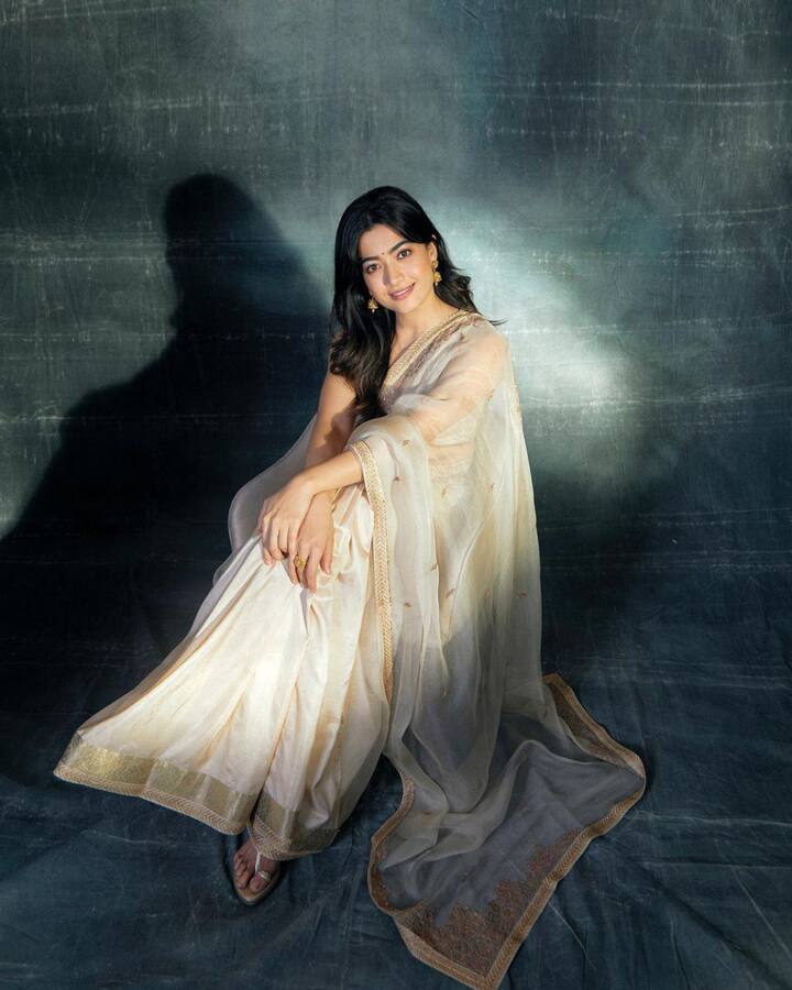 For the Ambani house Ganesh Chaturthi celebrations, Rashmika chose a cream-colored saree. Paired with a sleeveless blouse and jhumkas, her look epitomized the seamless fusion of tradition and modernity, making a striking statement at the festive occasion.