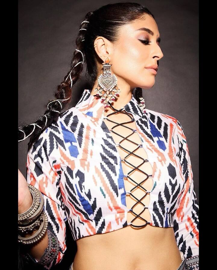 She accessorised with silver statement earrings.
