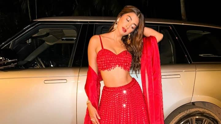 Pooja Hegde wore an exquisite red lehenga designed by Arpita Mehta to a wedding.