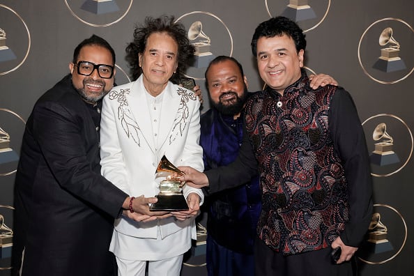 Shakti band, including Zakir Hussain, John McLaughlin, violinist Ganesh Rajagopalan, and percussionist Selvaganesh Vinayakram, won Global Music Album award at the Grammy Awards for their album 'This Moment.'