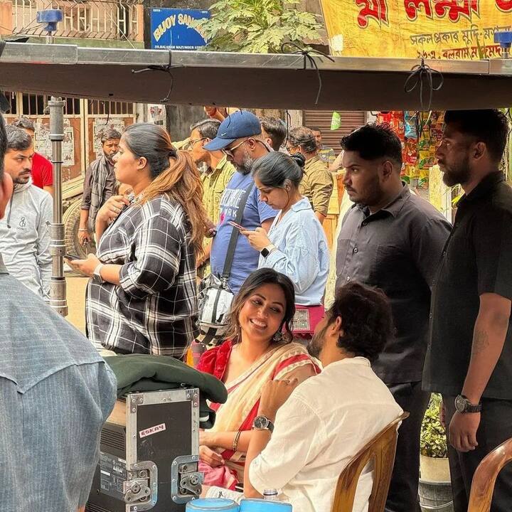 The two are seen laughing heartily and engaging in a conversation.