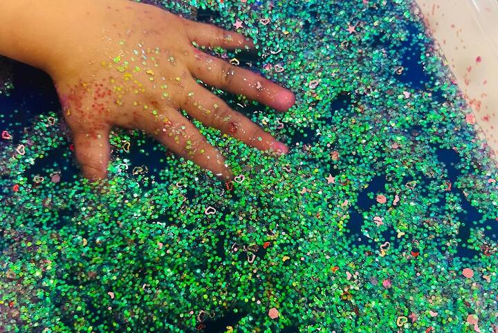 The image shows Malti's hand coated in glitter.