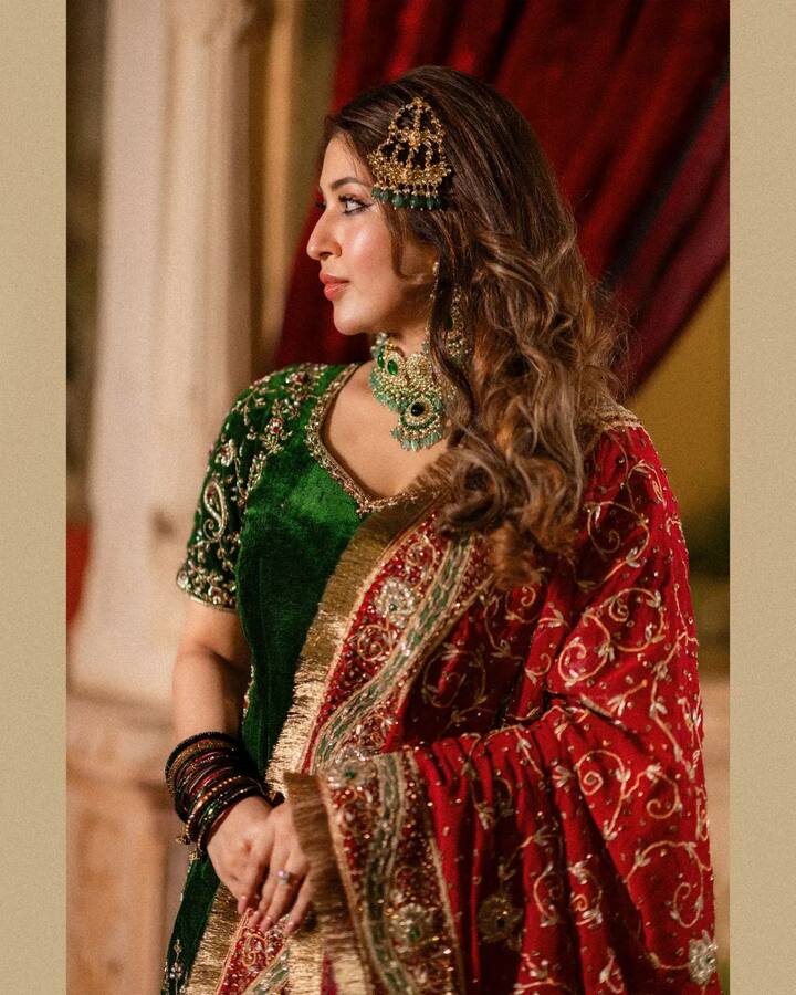 The actress wore a green velvet choli, paired with red lehenga and matching dupatta. She sported a green neckpiece, matching earrings, a side 'maang teeka' and red bangles. The look was rounded off with glossy makeup.