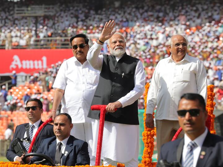 Prime Minister Narendra Modi, with Gujarat Chief Minister Bhupendra Patel and state BJP President CR Paatil, greets the gathering during the golden jubilee celebrations of Gujarat Cooperative Milk Marketing Federation, in Ahmedabad. (Photo: PTI)