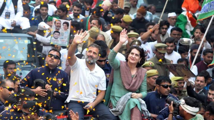 Rahul and Priyanka were seen sitting on a red jeep, waving at the supporters who had gathered along the sides of the road and showered petals on them to welcome them. (Source: PTI)