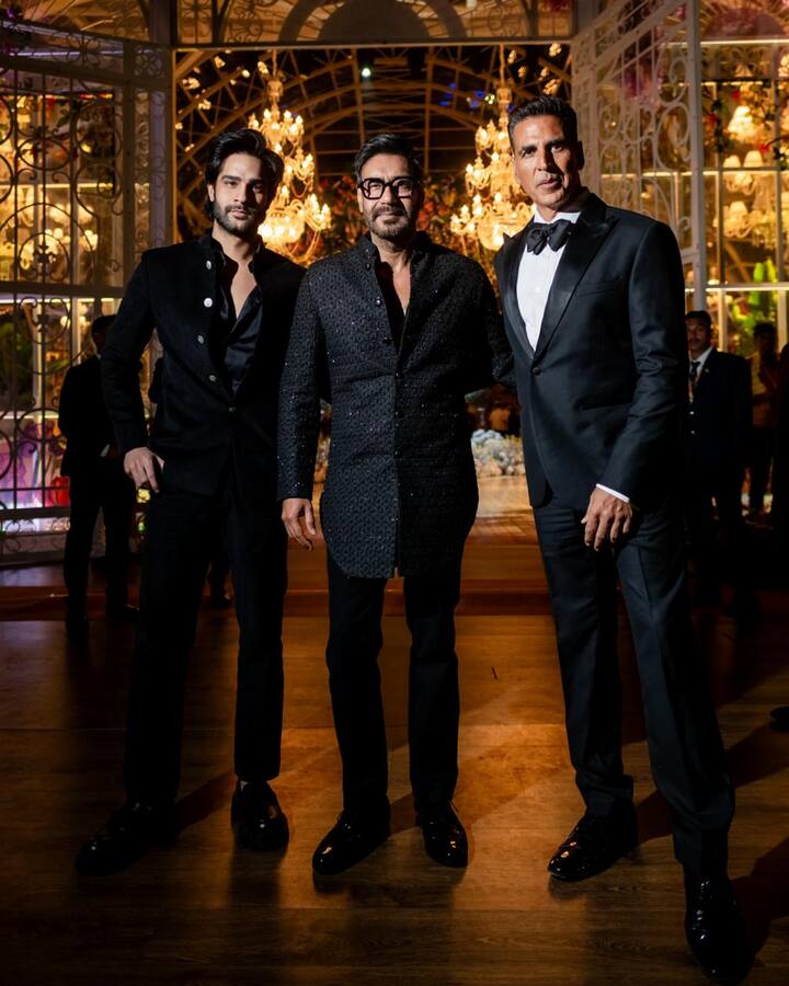 Dynamic duo Ajay Devgan and Akshay Kumar strike a pose at the star-studded pre-wedding event in Jamnagar. Ajay shines in a shimmery black kurta and pants, while Akshay exudes sophistication in a classic formal tuxedo. Also accompanying Ajay is his nephew, Aaman Devgan, who is looking sharp in black formals. (Image source: Manav Manglani)
