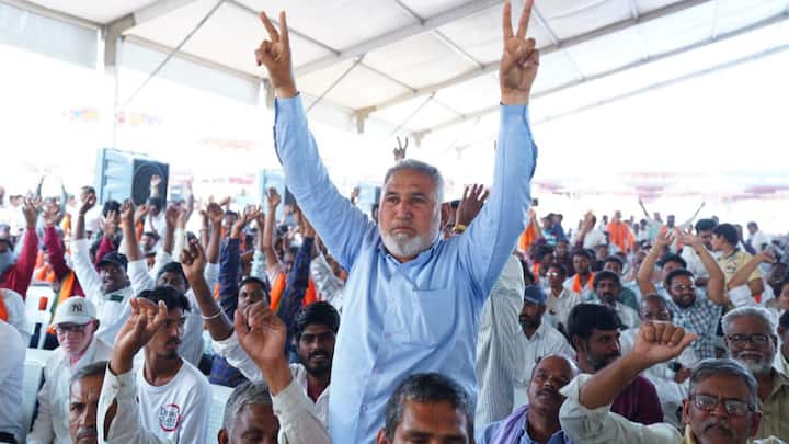 A man stands up to cheer for the prime minister along with others at Adilabad in Telangana.  (Photo: X/@BJP4Telangana)