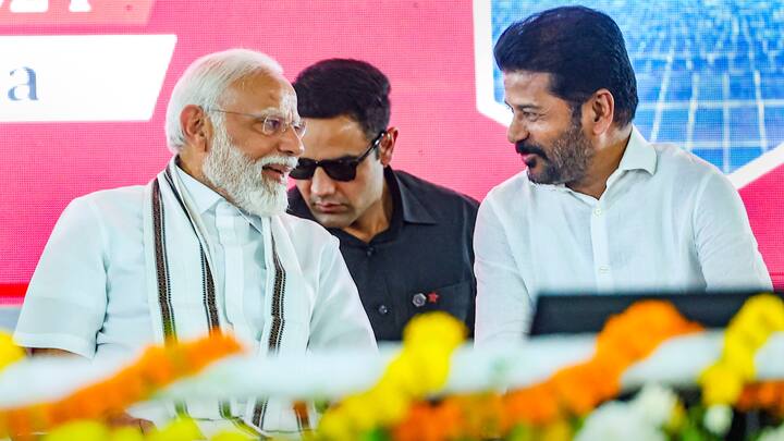 PM Modi interacts with Telangana CM Revanth Reddy during the launch of development initiatives, in Adilabad, Telangana. In his address, Revanth Reddy said PM means like a big brother and that the state needs his support for it to progress like Gujarat, Modi's home-state. (Photo: PTI)