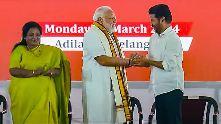 Prime Minister Narendra Modi shakes hands with Telangana Chief Minister A Revanth Reddy in Adilabad. (Photo: PTI)