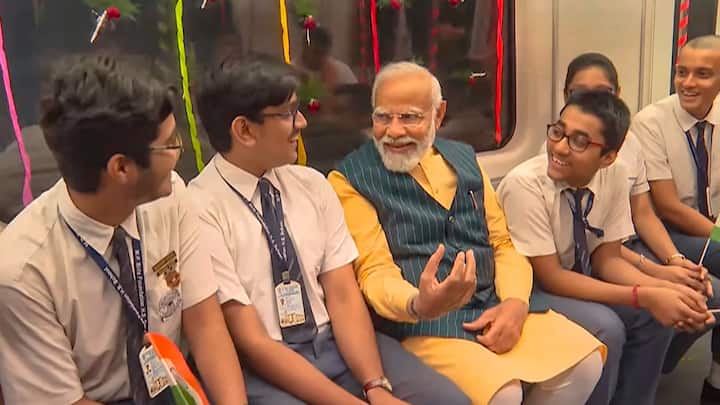 After inaugurating the train, the prime minister took a ride in the company of school children. He was seen interacting and sharing laughs with them during the underwater metro ride. (Source: PTI)