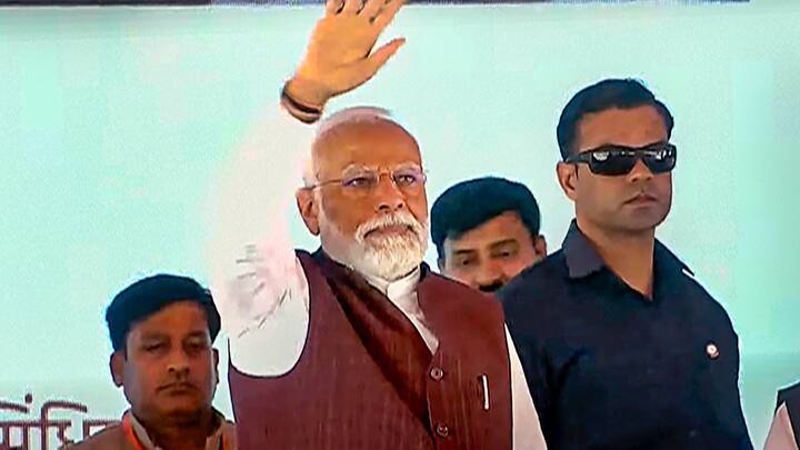 PM Modi waving at the crowd during the event. During his address, he said that, Azamgarh, which was once considered backward, is a shining star today and writing a new chapter of development for the country. (Photo: PTI)