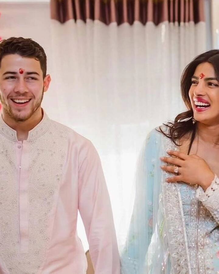 Priyanka is wearing a blue and white printed suit, while Nick Jonas complements her look in a pink and golden kurta paired with white pyjamas.