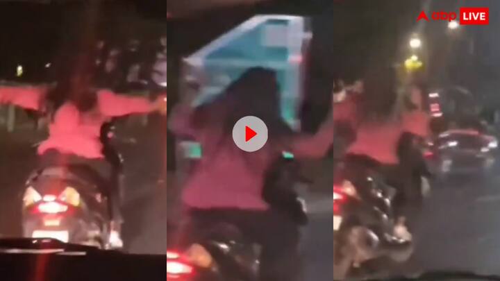 A girl on a fast scooter is dancing on the song Hawa Hawai leaving both her hands Video: सड़क पर तेज रफ्तार स्कूटी से लड़की का खतरनाक स्टंट, वीडियो देख यूजर्स बोले- 'पापा की परी को...'