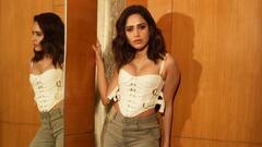 Nushrratt Bharuccha Sets The Temperature Soaring In White Corset Top & Grey Flare Denims