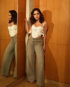 Nushrratt Bharuccha Sets The Temperature Soaring In White Corset Top & Grey Flare Denims