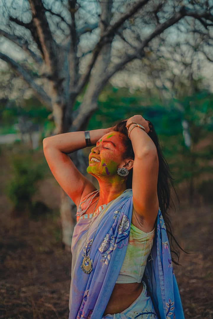Apply enough oil to your hair before playing Holi.  It acts as a barrier between your hair and the dye, making it easier to clean your hair after playing Holi.  (Photo Credit: Pexels)