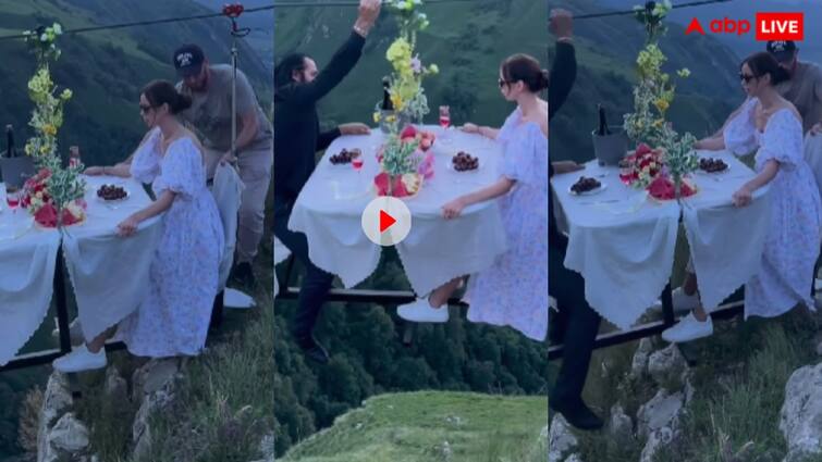 Couple hanging in air and enjoying their dinner date goes viral on social media trending Video: 'जिंदगी से मन भर गया है शायद', कपल ने हजारों फीट हवा में लगवाई अपनी डिनर टेबल तो बोले यूजर्स