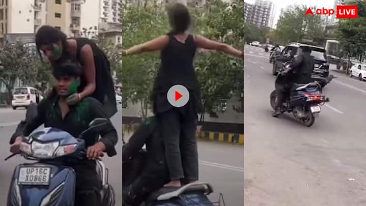 Girl doing stunt on moving scooter on the occasion of Holi in Noida fell on her face watch video Video: चलती स्कूटी पर होली मना रही लड़की मुंह के बल गिरी, होली पर अजीब हरकत का वीडियो वायरल