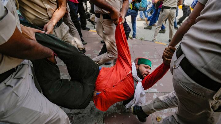 Security personnel detain AAP workers during their protest outside Patel Chowk metro station against the arrest of Delhi CM Arvind Kejriwal, in New Delhi. (Photo: PTI)