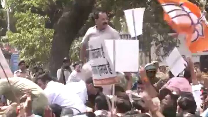 Delhi BJP President Virendra Sachdeva was raised by the crowd during their protest demanding the resignation of Delhi CM Arvind Kejriwal. (Photo: ANI)