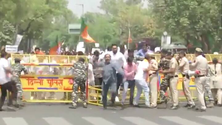 BJP protestors break barriers to move towards the Secretariat during their protest demanding the resignation of Delhi CM Arvind Kejriwal. (Photo: ANI)