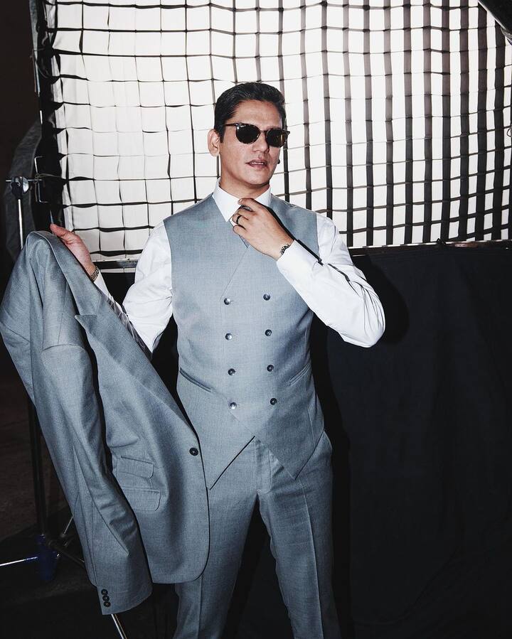 Donning a gray pantsuit, Vijay exuded modern elegance and sophistication.