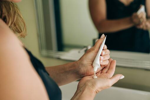 Eye Cream: Gently dab on an eye cream formulated to hydrate, firm, and brighten the delicate skin around the eyes, helping to reduce the appearance of dark circles and fine lines. (Image Source: Getty)