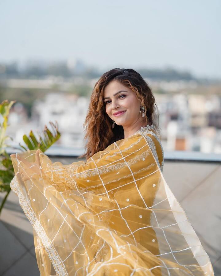 Her latest pictures feature her dressed in a yellow suit and radiating sunshine glow.