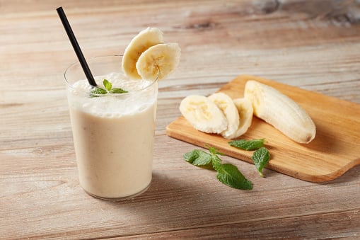 Frozen banana smoothie: If you're short on time and feeling thirsty after a workout, you can make a quick and refreshing smoothie by blending a frozen banana, mixed berries, a tablespoon of almond butter, and unsweetened almond milk. The frozen fruit will give the smoothie a refreshing chill, and the almond butter and almond milk will add a nutty flavor while providing calcium, vitamin D, vitamin E, and the hydration you need before stepping into the sun. (Image Source: Getty)