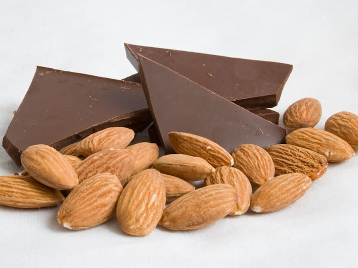 image 7Dark chocolate with almonds: Although dark chocolate offers good health benefits, the sugar content can still spike the glucose levels. Dark chocolates contain 50-90% of cocoa solids, butter and sugar and is fairly high in calories and fat. It has less sugar than white chocolate but the presence of sugar will still impact your glucose levels. Pairing with almonds or nuts that are a good source of proteins, can help slow down sugar spike and keep you satiated. (Image source: getty images)