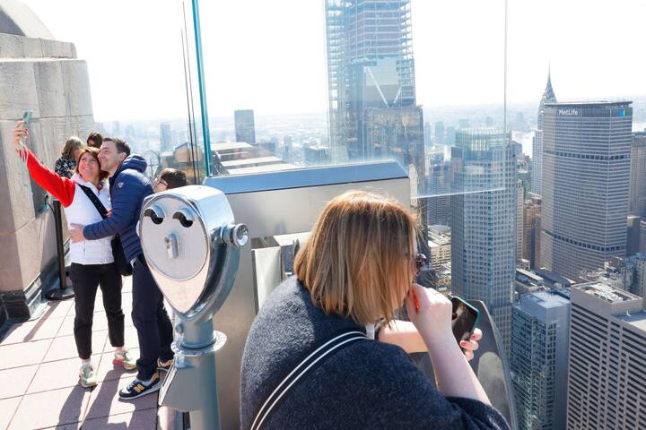 People enjoy the view from from the Top of the Rock at Rockefeller Center before the start of a partial solar eclipse on April 08, 2024 in New York City. (Getty Image)