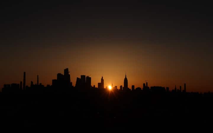 While residents of India may not have the privilege of witnessing this extraordinary event firsthand, the excitement among sky gazers around the world is palpable. Here, The sun rises behind the skyline of midtown Manhattan and the Empire State Building on the day of the solar eclipse in New York City on April 8, 2024. (Getty Image)