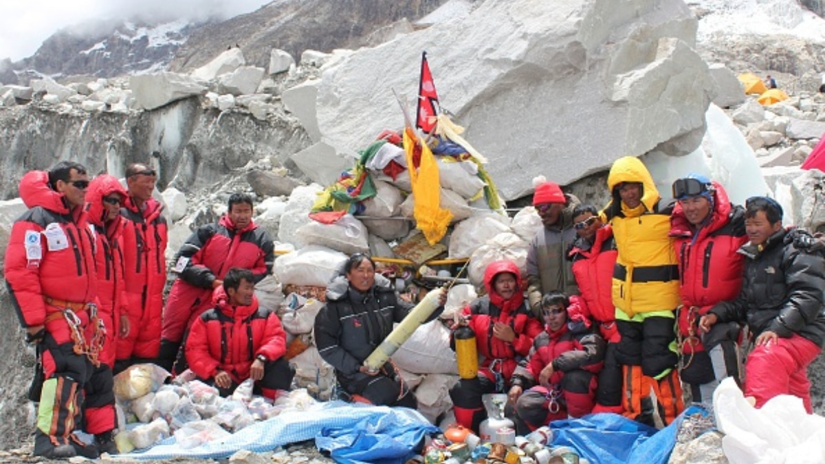 Nepalese sherpa climbers posing after collecting garbage from the Everest clean-up expedition at Everest Base Camp. (Image Source: Getty)