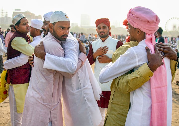 Muslim men greet each other during Eid-al-Fitr celebrations, at Leisure Valley ground, in Gurugram. (Image Source: PTI)