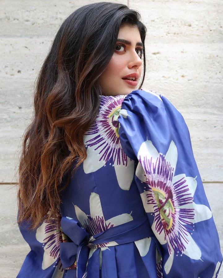 Sanjana posed in a blue dress with huge white flowers all over it and a ribbon at the back. (Image Source: Special Arrangement)