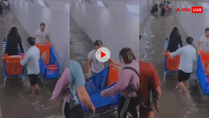 Shopping complex staff are taking money to rescue people trapped in floods in Dubai trending Video: दुबई में आई बाढ़ के बाद लोगों ने लगाया गजब का दिमाग... बाढ़ के पानी से कमाने लगे पैसा