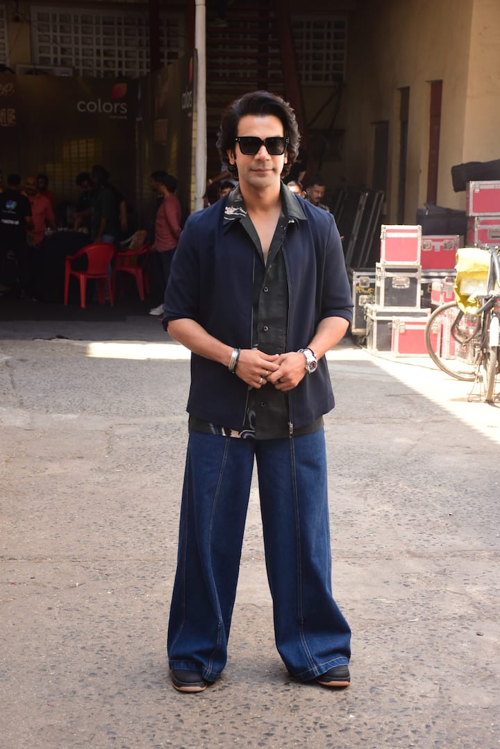 Rajkummar Rao opted for a black printed shirt that he paired with dark blue flared jeans.