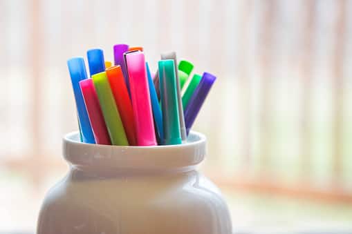3. Pencil Holders: Cut off the top portion of a plastic bottle, decorate it, and use it as a pencil holder or desk organizer. This eco-friendly alternative reduces waste and adds a personalized touch to your workspace. (Image Source: Getty)