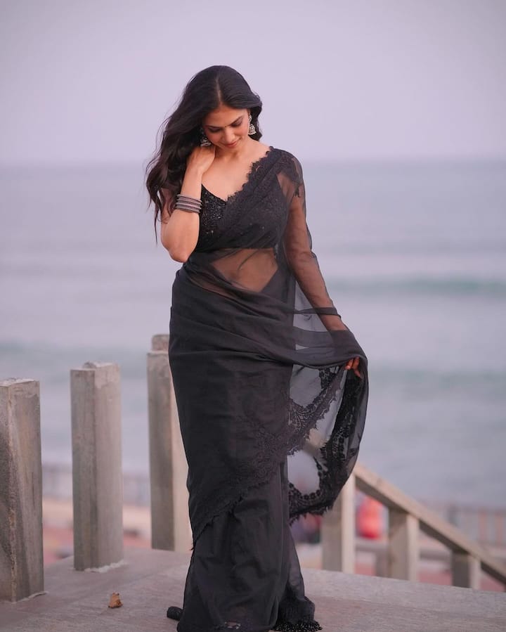 The actress can be seen flaunting her svelte figure in the see-through saree.