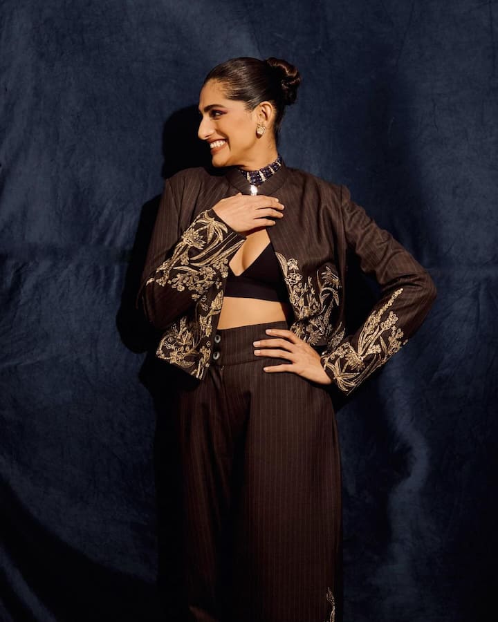 Kubbra Sait treated fans with pictures in a black dusky pant suit