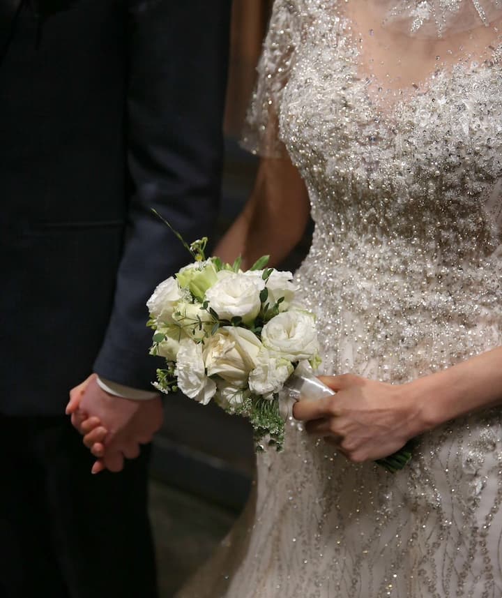 Anda shared a close-up photo of her husband and herself wearing their wedding attire.