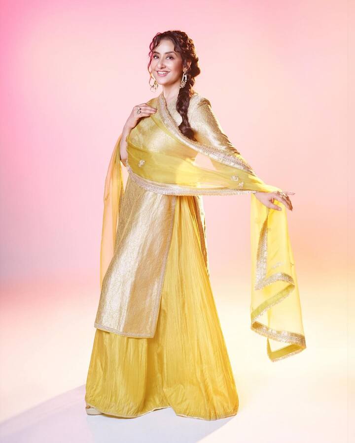 She wore it with a yellow wide-legged sharara.