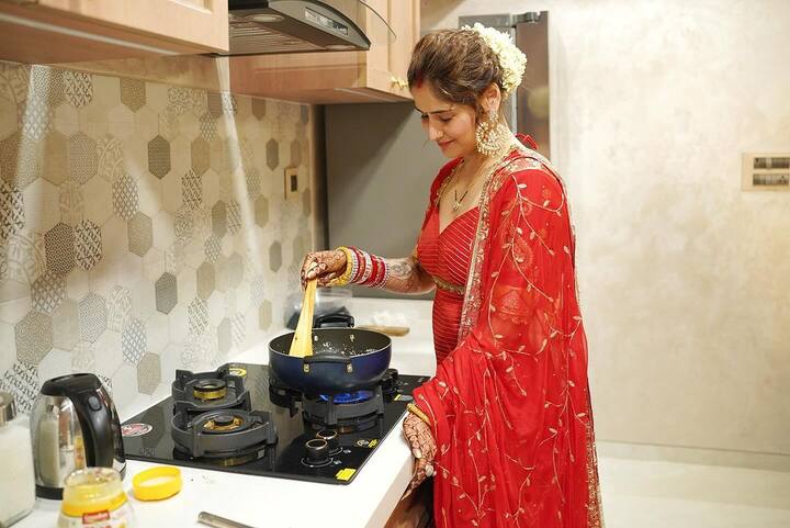 The photos feature her wearing a bright red coloured ethnic suit, with a matching dupatta. She opted for minimal makeup, her hair tied in a bun with a gajra on it.