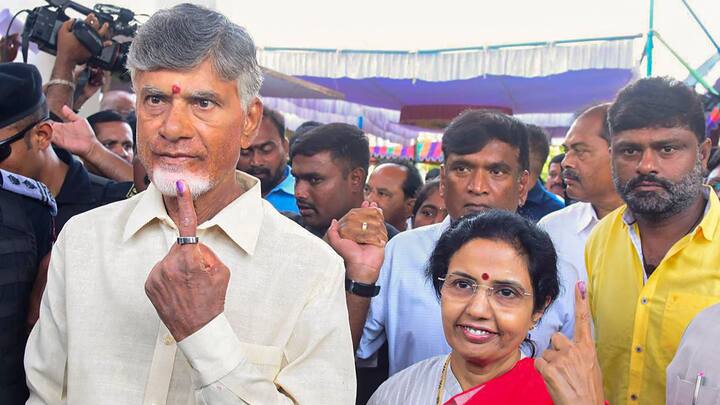 Telugu Desam Party Chief N Chandrababu Naidu and wife Nara Bhuvaneshwari show their ink-marked finger after casting votes in Undavalli, Andhra Pradesh. (Photo: PTI)