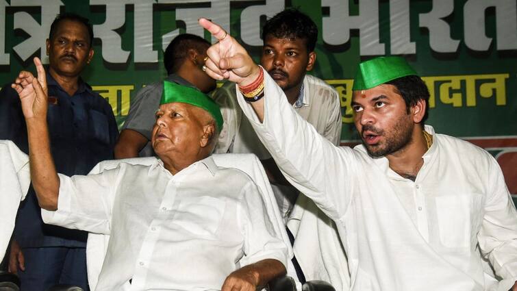 Tej Pratap Gets Angry Shoves RJD Workers On Stage, Audience Left Astonished Watch Video Lok Sabha Elections 2024 RJD's Tej Pratap Yadav Shoves Party Workers During Misa Bharti's Nomination Rally — WATCH