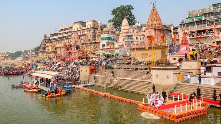 People gather near Dashashwamedh Ghat in Varanasi to watch PM Modi perform ‘Ganga Poojan’ on Tuesday. (Photo: PTI)
