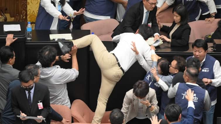 Taiwanese Parliament Brawl Member Snatches Bill Runs Away To Keep It From Passing Chaotic Scenes At Taiwanese Parliament As MP Snatches Bill, Lawmakers Exchange Blows: Watch