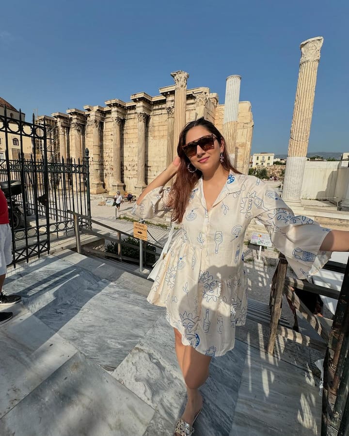 She has kept her hair open and accessorised the look with black sunglasses, earrings, and silver slippers.