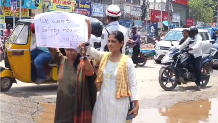 Hyderabad Woman Sits In Flooded Crater To Protest Potholed Roads In City: WATCH Hyderabad Woman Sits In Flooded Crater To Protest Potholed Roads In City: WATCH